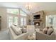 Inviting living room with a stone fireplace, light gray walls, and french doors to the outside at 4120 Grady Smith Rd, Loganville, GA 30052