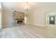 Bright, unfurnished living room featuring a stone fireplace and wood-look flooring at 4120 Grady Smith Rd, Loganville, GA 30052