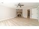 Spacious living room with stone fireplace, ceiling fan, and modern neutral decor at 4120 Grady Smith Rd, Loganville, GA 30052