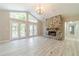 Bright and airy living room with stone fireplace, French doors, and hard wood flooring at 4120 Grady Smith Rd, Loganville, GA 30052