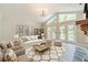 Bright living room featuring large windows, a cozy sofa, and stylish decor at 4120 Grady Smith Rd, Loganville, GA 30052