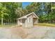 Cozy shed with a gabled roof, awning, and board and batten siding at 4120 Grady Smith Rd, Loganville, GA 30052