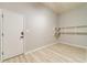 Versatile storage area with floating shelves and durable wood laminate flooring at 4120 Grady Smith Rd, Loganville, GA 30052