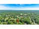 Aerial view of a home in a lush, green neighborhood under a clear blue sky at 4385 Pinehollow Court Ct, Alpharetta, GA 30022