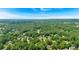 Expansive aerial view of a residential area with homes nestled among lush trees and greenery at 4385 Pinehollow Court Ct, Alpharetta, GA 30022