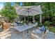 Serene backyard with outdoor dining and lounge area, perfect for gatherings and relaxation at 4385 Pinehollow Court Ct, Alpharetta, GA 30022