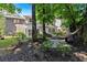Spacious backyard with a hammock, patio area, and lush landscaping for outdoor enjoyment at 4385 Pinehollow Court Ct, Alpharetta, GA 30022