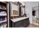 Elegant bathroom with a double vanity, dark cabinetry, and stylish mirrors, providing a sophisticated design at 4385 Pinehollow Court Ct, Alpharetta, GA 30022