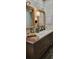 Modern bathroom featuring wood cabinets, a large vanity, and and sinks at 4385 Pinehollow Court Ct, Alpharetta, GA 30022