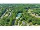 Aerial view of the community amenities, including a pool and tennis courts, surrounded by trees at 4385 Pinehollow Court Ct, Alpharetta, GA 30022