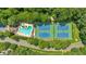 Aerial view of the community pool and tennis courts surrounded by lush greenery at 4385 Pinehollow Court Ct, Alpharetta, GA 30022