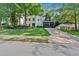 Inviting white-brick home featuring a lush green lawn and a driveway leading to a two-car garage at 4385 Pinehollow Court Ct, Alpharetta, GA 30022