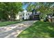 Attractive white-brick house with a well-maintained lawn and a spacious driveway leading to a two-car garage at 4385 Pinehollow Court Ct, Alpharetta, GA 30022