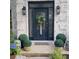 Elegant front door with decorative glass, surrounded by lush greenery and stylish planters at 4385 Pinehollow Court Ct, Alpharetta, GA 30022