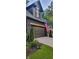 Close up of a dark colored garage door featuring an American Flag with well manicured bushes at 4385 Pinehollow Court Ct, Alpharetta, GA 30022