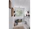 Bright hallway with white railings and decorative plants near a window, creating a fresh and welcoming space at 4385 Pinehollow Court Ct, Alpharetta, GA 30022