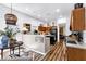 Open kitchen with island seating, stainless appliances, and open floor plan at 4385 Pinehollow Court Ct, Alpharetta, GA 30022