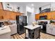 Bright kitchen with center island, oak cabinets, stainless appliances and modern decor at 4385 Pinehollow Court Ct, Alpharetta, GA 30022