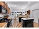 Modern kitchen with a view from the sink, featuring an island with seating and stainless appliances at 4385 Pinehollow Court Ct, Alpharetta, GA 30022