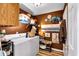 Functional laundry room features a washer, dryer, shelving, and decorative accents on warm-toned walls at 4385 Pinehollow Court Ct, Alpharetta, GA 30022