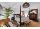 Beautiful main bedroom with a four-poster bed, tropical decor, and natural light, offering a relaxing retreat at 4385 Pinehollow Court Ct, Alpharetta, GA 30022