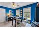 Bright home office featuring blue walls, lots of natural light, and ample desk space for working from home at 4385 Pinehollow Court Ct, Alpharetta, GA 30022