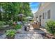 Charming backyard patio with ample seating and a beautiful garden, perfect for outdoor entertaining at 4385 Pinehollow Court Ct, Alpharetta, GA 30022