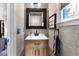 Charming powder room with a stylish mirror, decorative wallpaper, and a modern sink with wooden vanity at 4385 Pinehollow Court Ct, Alpharetta, GA 30022