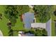An aerial view of a well-maintained home with a lush, green lawn and mature trees in a quiet neighborhood at 1410 Kingfield Dr, Johns Creek, GA 30005