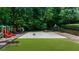 Outdoor basketball court and playground in a lush, wooded community at 1410 Kingfield Dr, Johns Creek, GA 30005