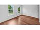 Bedroom with luxury vinyl plank flooring and two large windows at 1410 Kingfield Dr, Johns Creek, GA 30005
