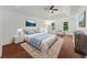 Bedroom featuring a tray ceiling, hardwood floors, and natural light at 1410 Kingfield Dr, Johns Creek, GA 30005