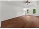 Spacious bedroom featuring a tray ceiling, hardwood floors, and natural light at 1410 Kingfield Dr, Johns Creek, GA 30005
