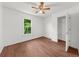 Bright bedroom with white walls, ceiling fan, hardwood floors, and closet at 1410 Kingfield Dr, Johns Creek, GA 30005