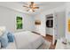 Bright bedroom with white walls, ceiling fan, hardwood floors, closet, and view to the outside at 1410 Kingfield Dr, Johns Creek, GA 30005