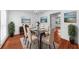 Elegant dining room featuring modern furnishings, hardwood floors, and views into the kitchen at 1410 Kingfield Dr, Johns Creek, GA 30005