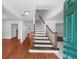 Bright entryway featuring a hardwood floor, white walls, and an open staircase leading to the second floor at 1410 Kingfield Dr, Johns Creek, GA 30005