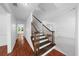 Inviting entryway featuring a staircase and wood floors, with an open view into adjacent rooms at 1410 Kingfield Dr, Johns Creek, GA 30005