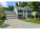 Traditional two-story home boasts a lush front lawn and an attached two-car garage, perfect for Gathering living at 1410 Kingfield Dr, Johns Creek, GA 30005