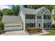 Inviting two-story home featuring a spacious front yard and a convenient attached two-car garage at 1410 Kingfield Dr, Johns Creek, GA 30005