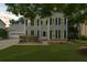 Charming two-story home with a well-manicured lawn and attached garage at 1410 Kingfield Dr, Johns Creek, GA 30005