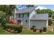 Back exterior view of a home with a deck, well-maintained lawn and mature landscaping at 1410 Kingfield Dr, Johns Creek, GA 30005
