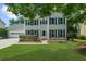 Charming two-story home with a well-maintained lawn, attached garage, and inviting front entrance at 1410 Kingfield Dr, Johns Creek, GA 30005