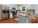 Well-equipped kitchen with stainless steel appliances, granite countertops, and modern white cabinetry at 1410 Kingfield Dr, Johns Creek, GA 30005