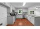 Spacious kitchen features stainless steel appliances, granite countertops and ample white cabinetry at 1410 Kingfield Dr, Johns Creek, GA 30005