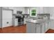 Bright kitchen with white cabinets, stainless steel appliances, and a stylish backsplash at 1410 Kingfield Dr, Johns Creek, GA 30005