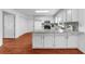 Bright kitchen featuring a large island, white cabinetry, granite countertops, and modern appliances at 1410 Kingfield Dr, Johns Creek, GA 30005