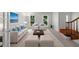 Comfortable living room featuring neutral tones, ample seating, and bright, natural light from the windows at 1410 Kingfield Dr, Johns Creek, GA 30005