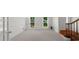 Spacious living room featuring plush carpeting, bright natural light, and an open doorway at 1410 Kingfield Dr, Johns Creek, GA 30005