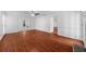 Open living room space with hardwood floors and a view into other rooms, providing ample space for living at 1410 Kingfield Dr, Johns Creek, GA 30005